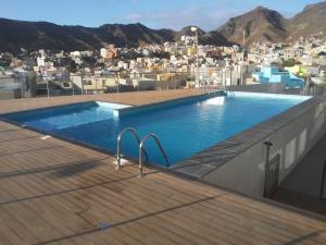 a swimming pool on the roof of a building at Ocean View Stay in Mindelo