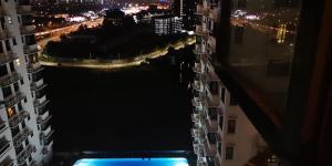 a view of a city at night with buildings at The Heritage Residence in Seri Kembangan