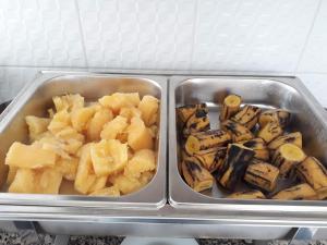 two metal containers of food in a refrigerator at Hotel Plaza Campo Grande in Salvador