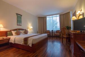 a hotel room with a bed and a flat screen tv at Khemara Angkor Hotel & Spa in Siem Reap