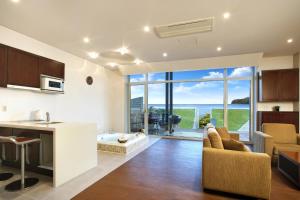 a kitchen and living room with a view of the ocean at Tropical Dream Spa Resort in Geoje