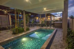 a swimming pool in the middle of a house at VILLA PADDY in Kampung Padang Masirat