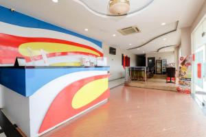 a lobby with a colorful wall in a building at Blitz Hotel Batam Tanjung Uncang in Sekupang