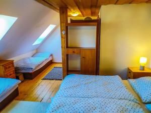 A bed or beds in a room at Zrub Liptovec