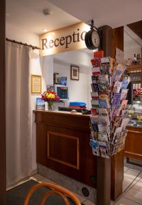 a restaurant with a reception desk with a clock at Pension-Café-Libelle in Elxleben bei Arnstadt