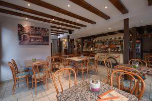 a restaurant with tables and chairs in a room at Pension-Café-Libelle in Elxleben bei Arnstadt