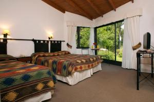 Cama ou camas em um quarto em Hotel Sierra Nevada