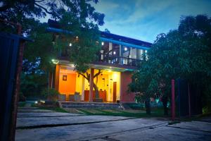 a large house with lights on the front of it at Thammenna Eco Cabins in Dambulla