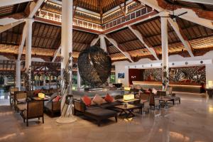 a lobby of a resort with couches and tables at Padma Resort Legian in Legian