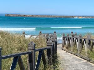a row of wooden posts near a body of water at Anchor Belle Motel in Warrnambool