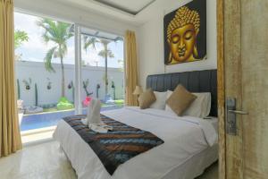 a bedroom with a large bed and a large window at Margarita Surf Hostel in Canggu