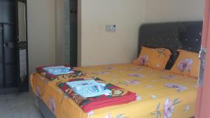 a bed with two pillows on top of it at Rome Residence Sibolga Pandan in Halangan