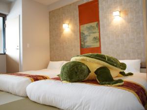 Kama o mga kama sa kuwarto sa Hotel Chula Vista SENAGA -SEVEN Hotels and Resorts-