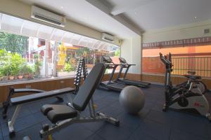 a gym with several treadmills and elliptical machines at KC Place Srinakarin in Bangna