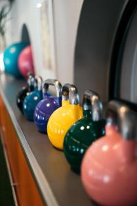 a row of colorful vases sitting on a counter at Comfort Hotel Grand Central in Oslo