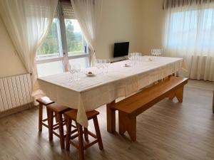 a large dining room table with wine glasses on it at A Casa do Lareiro in Sanxenxo