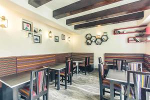 a dining room with tables and chairs in a restaurant at Bumblebee Bed & Breakfast in Gangtok