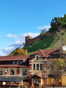a building with a castle on top of a hill at Domino Hotel in Nizhny Novgorod