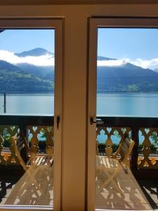 a room with two chairs and a view of the water at Appartement Harrer in Zell am See