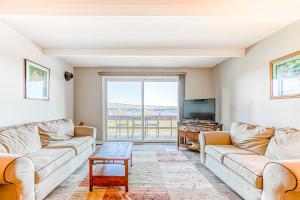 a living room with two couches and a tv at Squaw Village Condo in Greenville