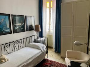 a bedroom with a bed and a chair at lungomare portoturistico in Chiavari