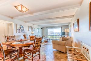 a living room with a table and chairs at Squaw Village Condo in Greenville