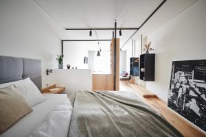 a bedroom with a bed in a room with white walls at Quartier am Bauernstadl in Feldbach