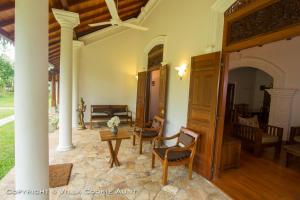 
a dining room with a wooden table and chairs at Villa Cookie Aunt in Bentota

