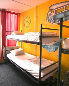 a bunk bed with two bunk beds in a room at The Flying Pig Beach Hostel in Noordwijk aan Zee