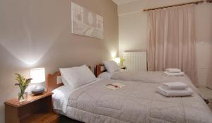 a hotel room with a bed and two lamps at Tsironis Guesthouse in Ioannina