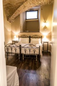 a bedroom with two beds and a window at la casa del vicolo - city center - in Perugia