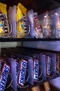 a shelf filled with lots of packs of candy bars at Taste Smart Hotel Lampertheim in Lampertheim