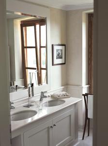 a bathroom with two sinks and a large mirror at Villa Arcadio in Salò
