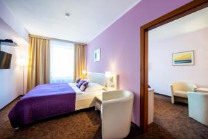 Uma cama ou camas num quarto em Hotel Mlynska