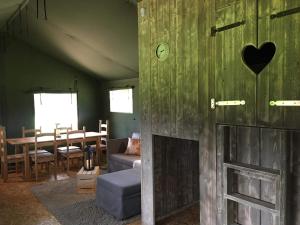 a living room with a couch and a fireplace at Wingfield Escapes in Diss