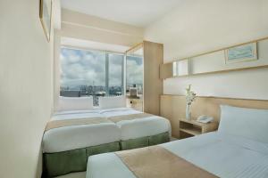A bed or beds in a room at Rambler Garden Hotel