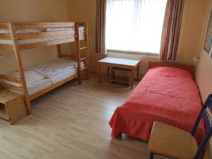 a bedroom with two bunk beds and a desk at Möwenhaus in Wangerland