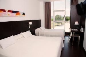 Postel nebo postele na pokoji v ubytování Hotel Sercotel Plana Parc