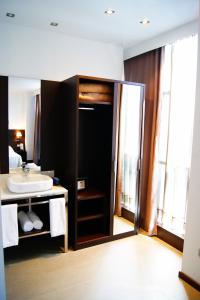 a bathroom with a sink and a shower backdoor at Hotel Sercotel Plana Parc in Alquerías del Niño Perdido
