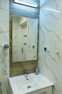 a bathroom with a white sink and a mirror at Agroturystyka Słoszówka in Duszniki Zdrój