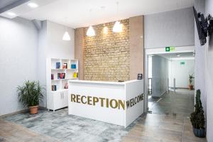 a reception room with a reception counter in a building at LIBERECO Aparthotel in Batumi