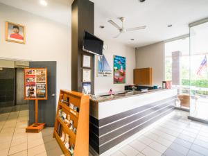 a lobby of a store with a counter at Kuala Melaka Inn in Pantai Cenang