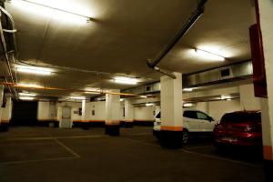 a parking garage with cars parked in it at Roisa Hostal Boutique in Madrid