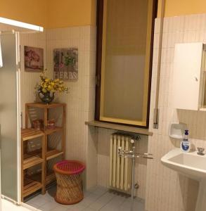 a bathroom with a sink and a toilet and a mirror at La Giara Rooms in Verona