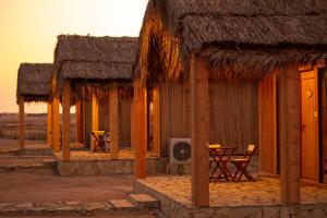 a building with a table and chairs in the desert at SAMA Ras Al Jinz Ecolodge in Sur