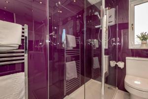 a purple bathroom with a shower and a toilet at Pilmour Place - 30 Seconds to the Old Course! in St Andrews