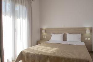 um quarto com uma cama grande e almofadas brancas em Villa Ourania em Ierissos
