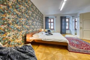 a bedroom with a large floral wall mural at CityLife Residence in Bratislava