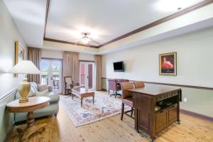 a living room with a couch and a table at Water Street Hotel & Marina, an Ascend Collection Hotel in Apalachicola