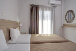 a bedroom with a large bed and a window at Villa Ourania in Ierissos